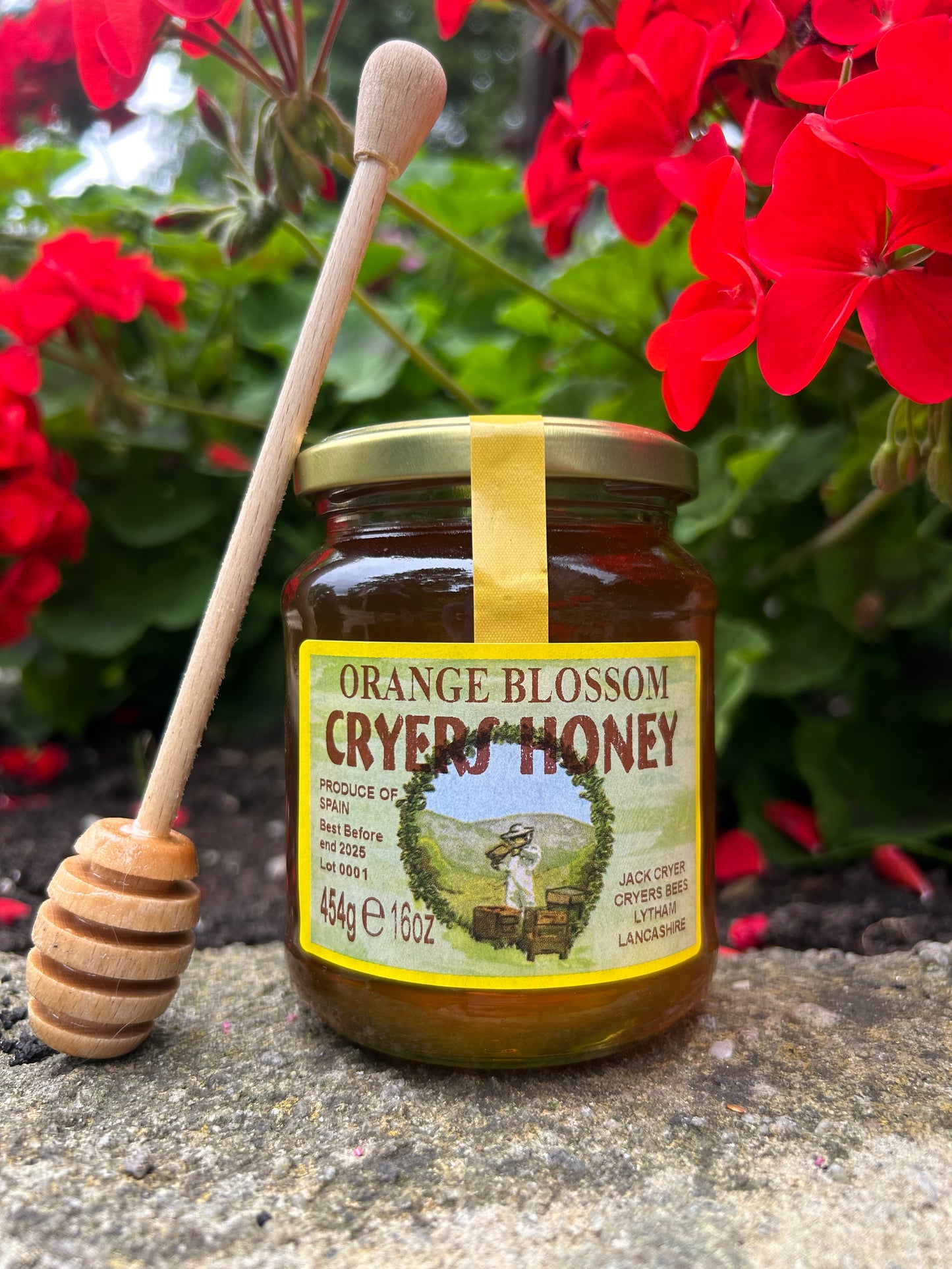 Close-up of Cryer’s Orange Blossom Honey jar with a honey dipper.